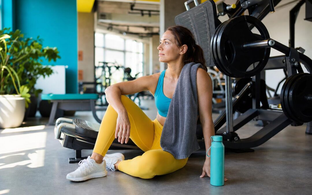Vrouw neemt een rustige waterpauze tijdens krachttraining op een warme dag